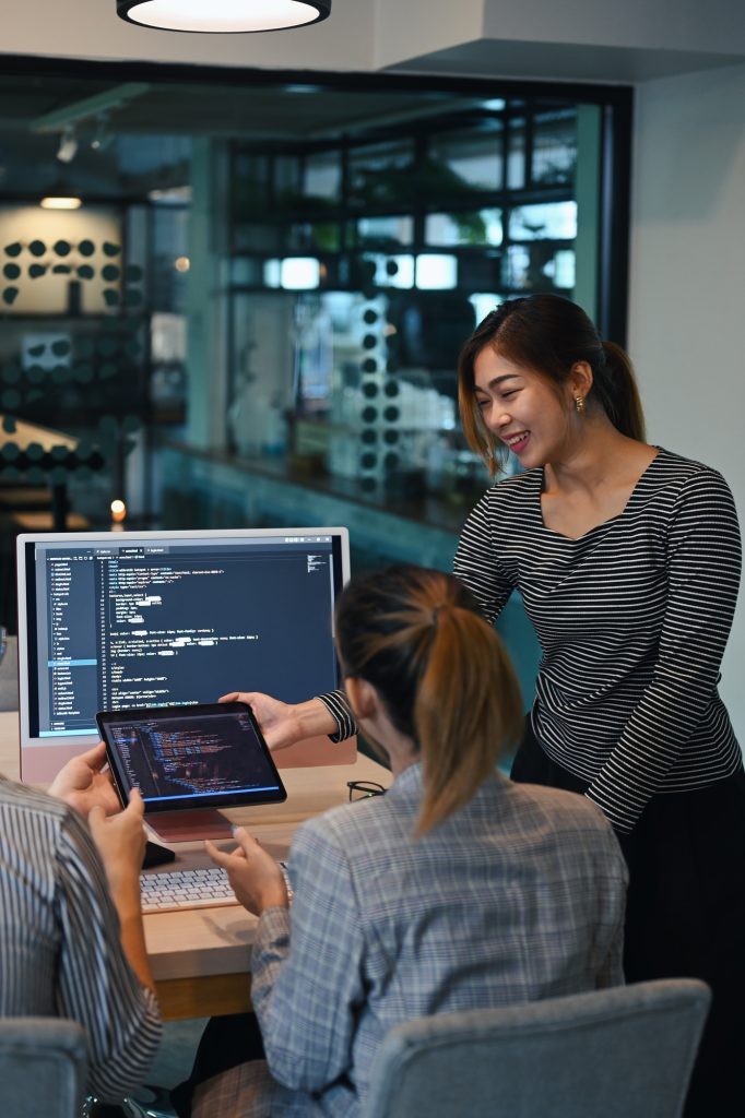 Female project supervisor explaining detail of project developing website design and coding.