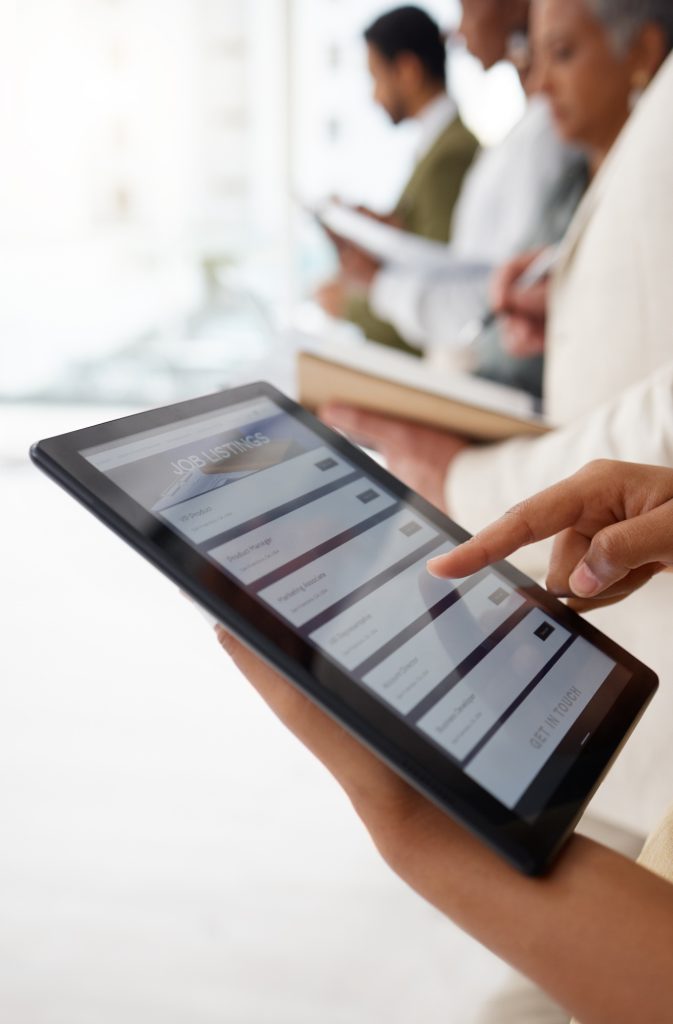 Hands, tablet and job listing advertising for hiring, opportunity or recruiting agency at the offic